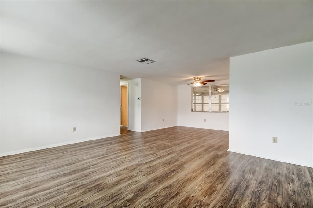 3735 Mynabird Drive New Port Richey, FL 34652 - Photo 11 of 51 a view of an empty room with wooden floor and a window