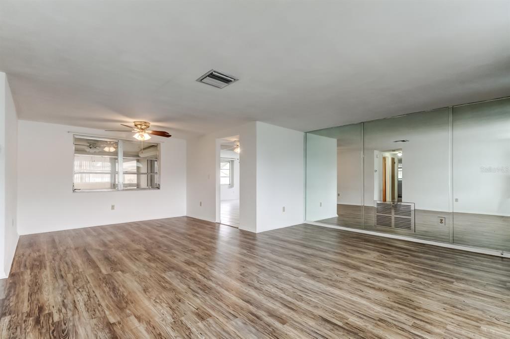 3735 Mynabird Drive New Port Richey, FL 34652 - Photo 12 of 51 an empty room with wooden floor and windows