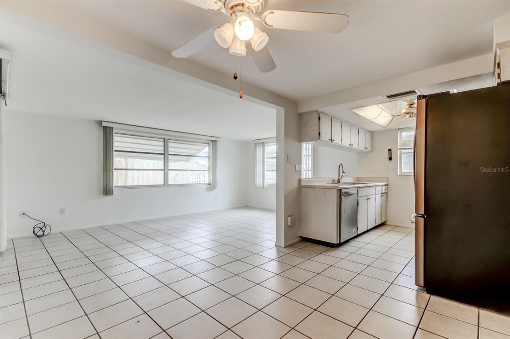 3735 Mynabird Drive New Port Richey, FL 34652 - Photo 13 of 51 a kitchen with stainless steel appliances a refrigerator and a stove top oven