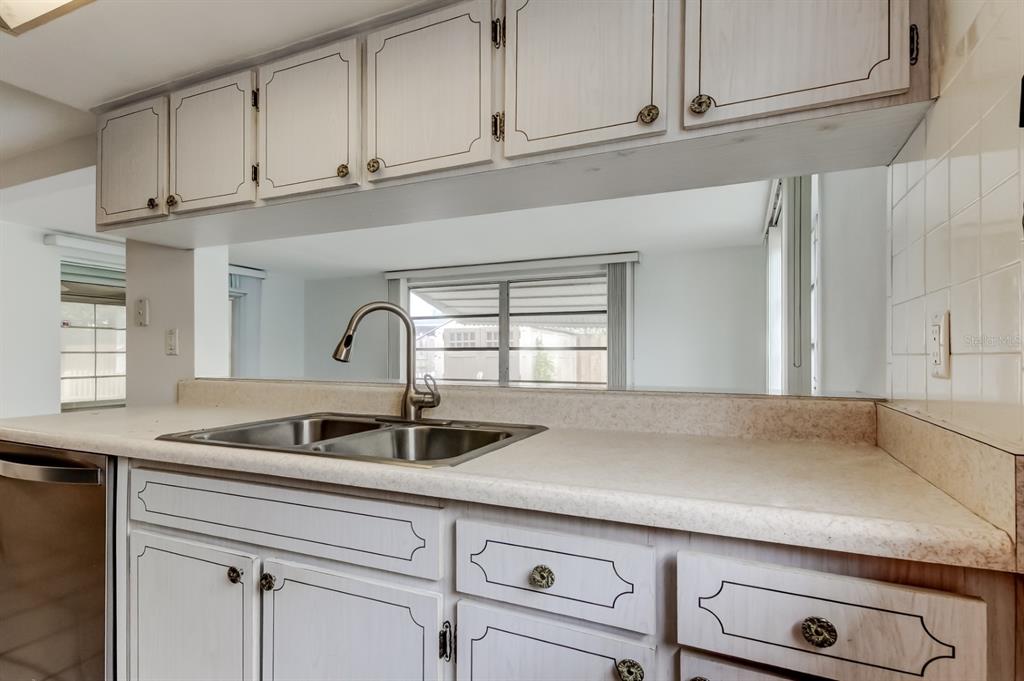 3735 Mynabird Drive New Port Richey, FL 34652 - Photo 23 of 51 a kitchen with granite countertop white cabinets and a sink