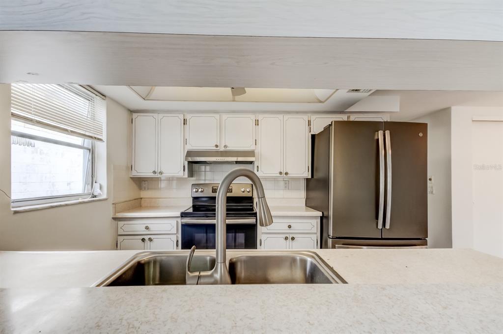 3735 Mynabird Drive New Port Richey, FL 34652 - Photo 24 of 51 a kitchen with stainless steel appliances a sink a stove and a refrigerator