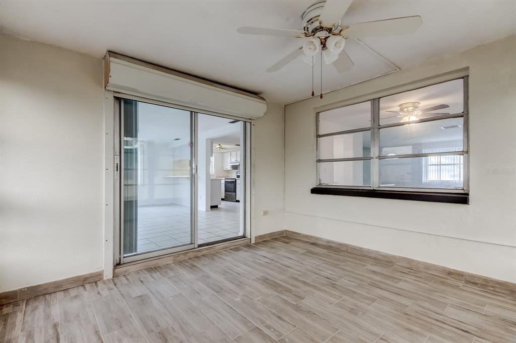 3735 Mynabird Drive New Port Richey, FL 34652 - Photo 31 of 51 an empty room with wooden floor and windows