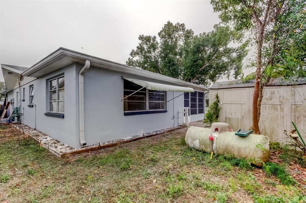 3735 Mynabird Drive New Port Richey, FL 34652 - Photo 49 of 51 a white house that has tree in front of it