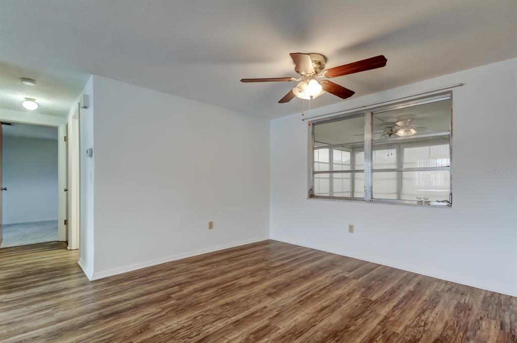 3735 Mynabird Drive New Port Richey, FL 34652 - Photo 6 of 51 a view of empty room with wooden floor and fan
