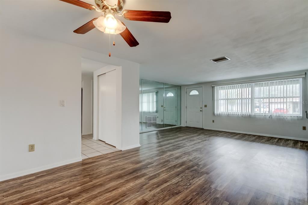 3735 Mynabird Drive New Port Richey, FL 34652 - Photo 7 of 51 wooden floor in an empty room with a window