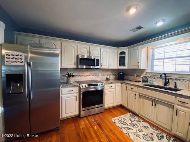 3555 Icetown Road Boston, KY 40107 - Photo 8 of 47 Eat in Kitchen with cream cabinetry, stainless appliances & hardwood floors