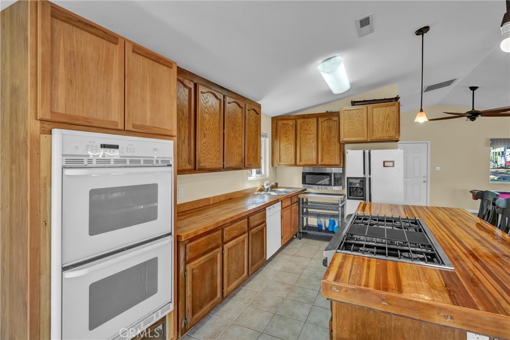 16410 Tish-A-Tang Road Lower Lake, CA 95457 - Photo 13 of 52 a kitchen with wooden cabinets and a stove top oven