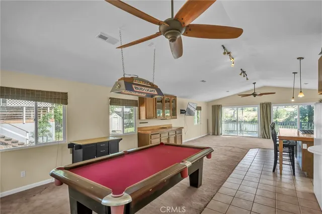 a living room with pool table and a window