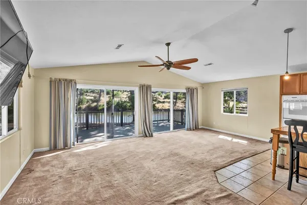 a view of a livingroom with a flat screen tv and windows
