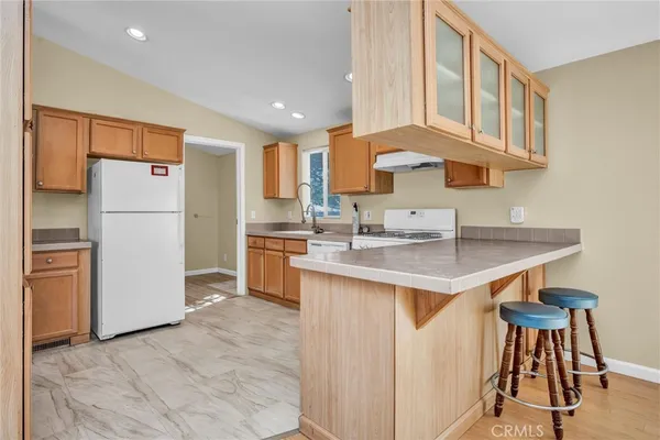 a kitchen with a sink cabinets and refrigerator