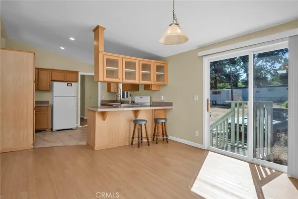 a kitchen with refrigerator and table