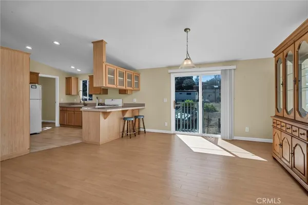 a view of a kitchen with stainless steel appliances granite countertop a stove and a refrigerator