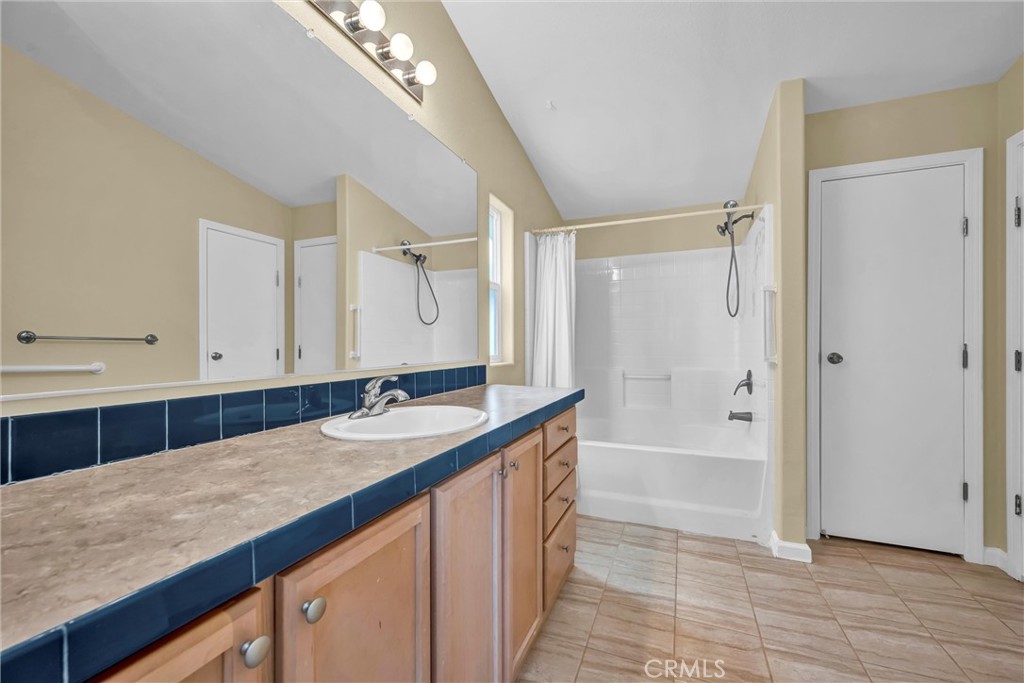 16410 Tish-A-Tang Road Lower Lake, CA 95457 - Photo 35 of 52 a bathroom with a granite countertop sink a mirror and a bathtub
