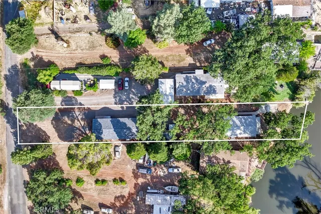 a view of a yard with wooden fence