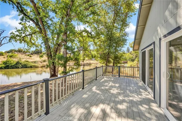 a view of a porch with wooden floor and fence