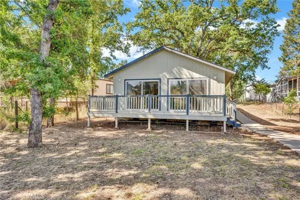 a house with a bench and trees