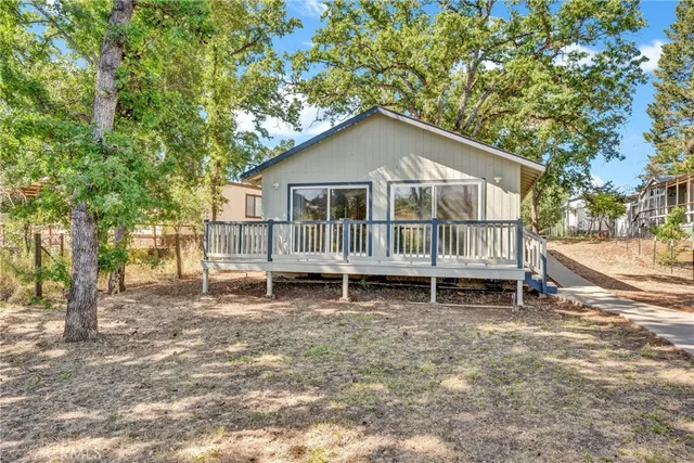 a house with a bench and trees