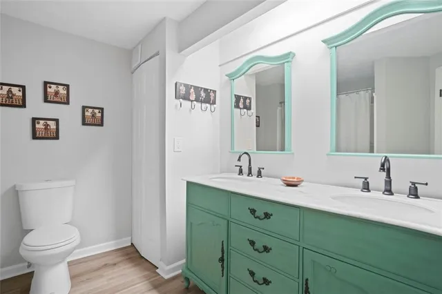 a bathroom with a toilet sink and mirror
