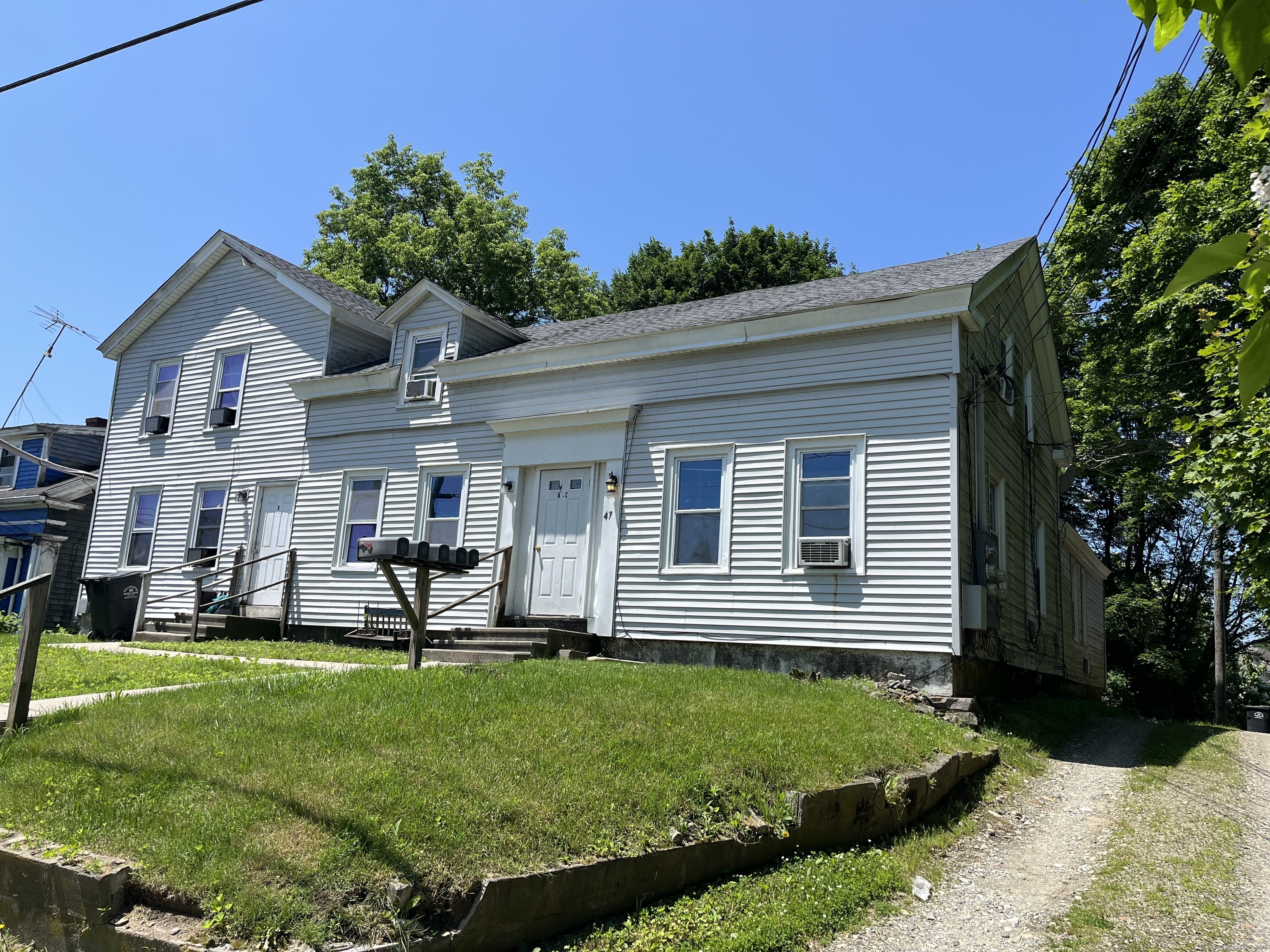 47 Commerce Avenue, Unit E Killingly, CT 06239 - Photo 1 of 1 a front view of a house with a yard