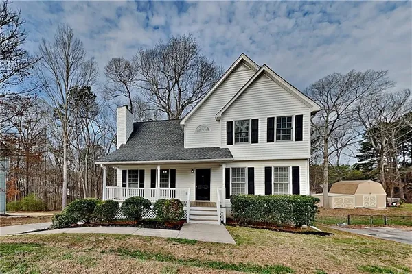 a front view of a house with a garden