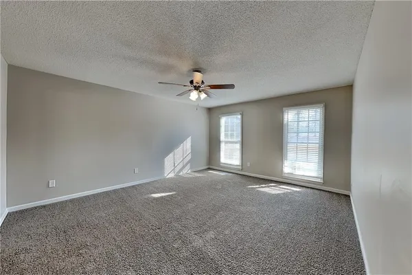 a view of a livingroom with a ceiling fan and window