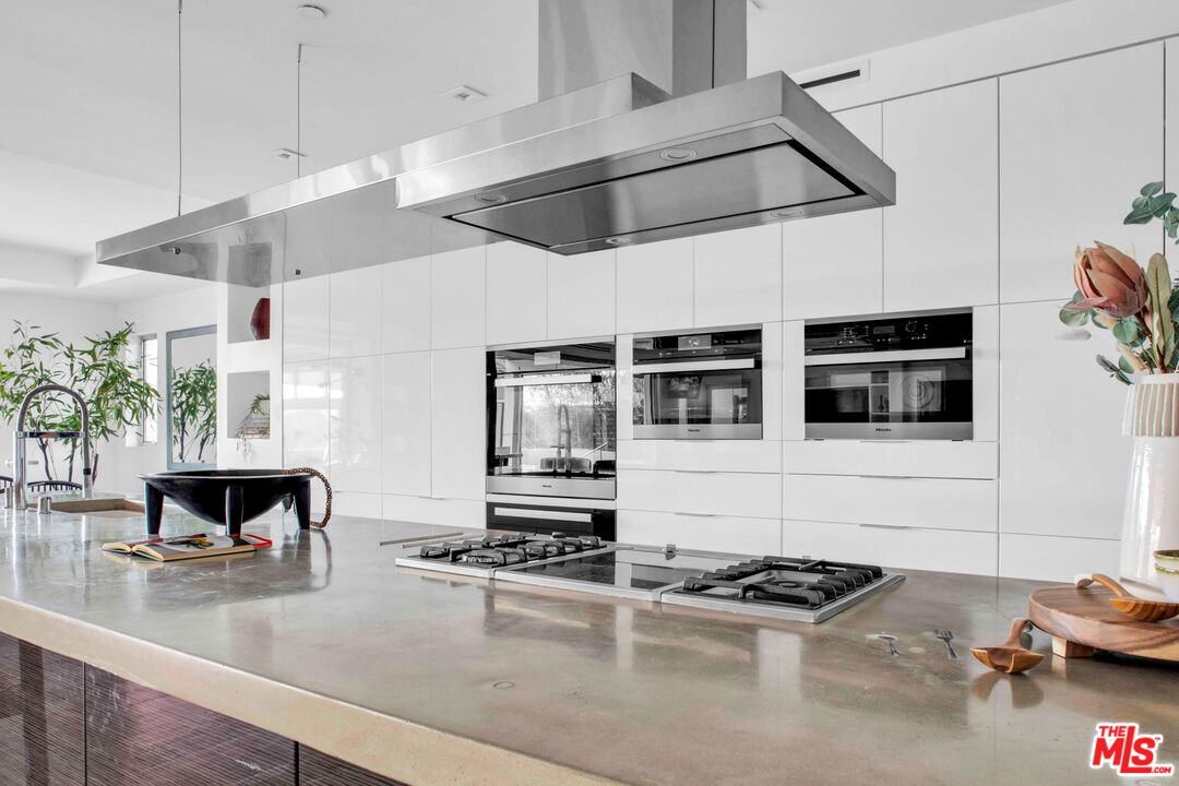 2945 Angus Street Los Angeles, CA 90039 - Photo 16 of 52 a kitchen with kitchen island a stove and a wooden floor