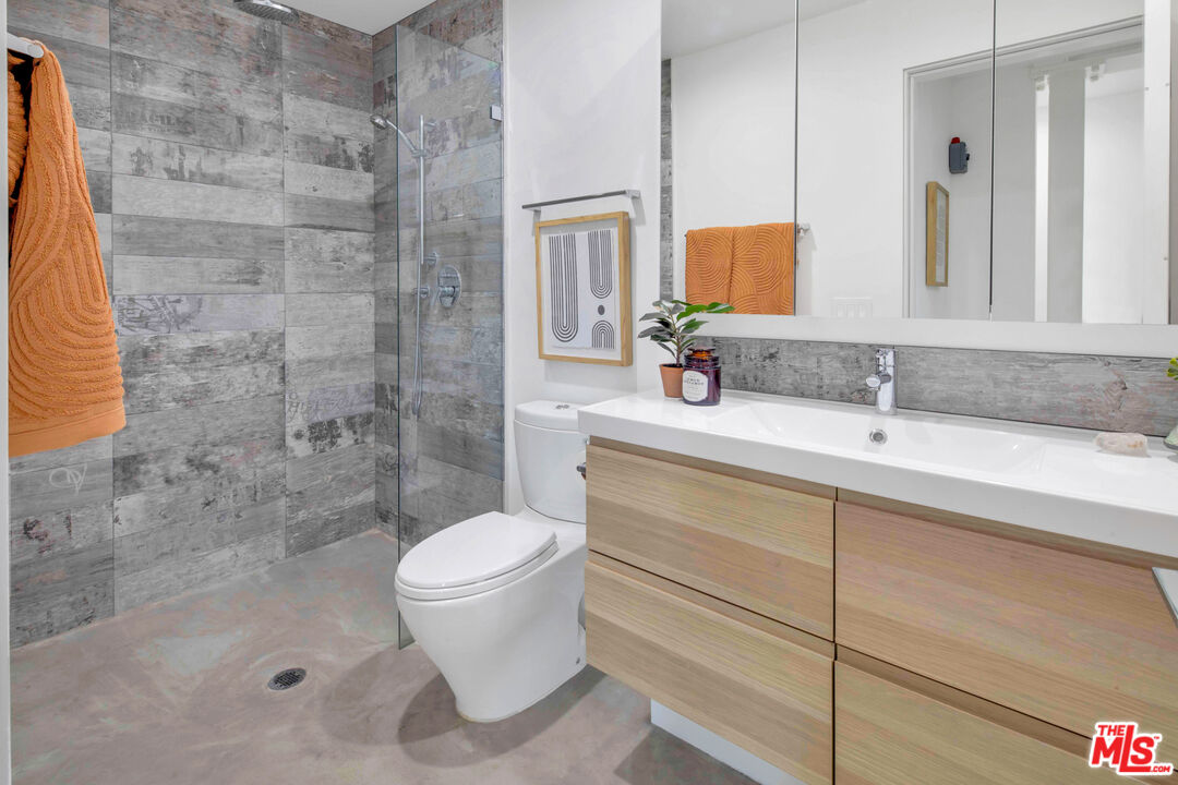 2945 Angus Street Los Angeles, CA 90039 - Photo 40 of 52 a bathroom with a sink a toilet and a mirror
