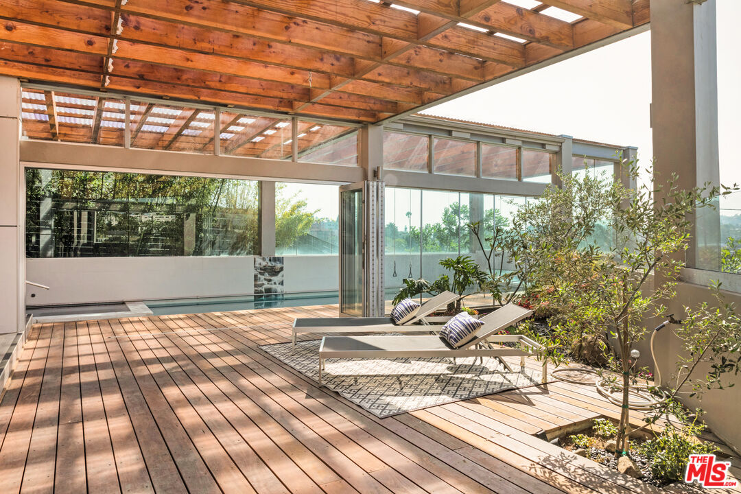 2945 Angus Street Los Angeles, CA 90039 - Photo 43 of 52 a view of a porch with wooden floor and furniture