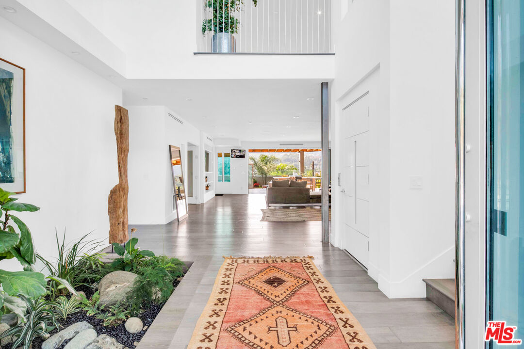 2945 Angus Street Los Angeles, CA 90039 - Photo 5 of 52 a hallway with a wooden floor and a potted plant