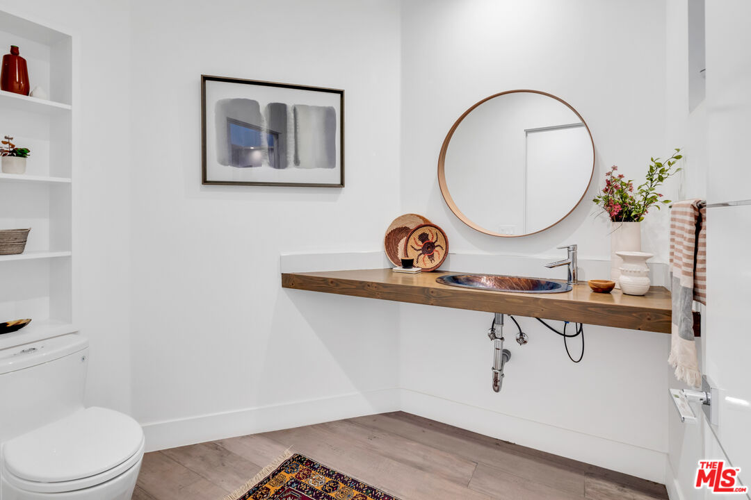 2945 Angus Street Los Angeles, CA 90039 - Photo 7 of 52 a bathroom with a toilet a sink and mirror