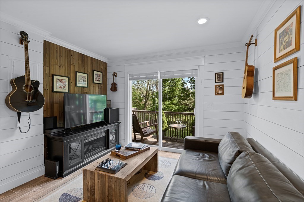 39 Liberty Square Road, Unit D Boxborough, MA 01719 - Photo 11 of 26 a living room with furniture and a flat screen tv