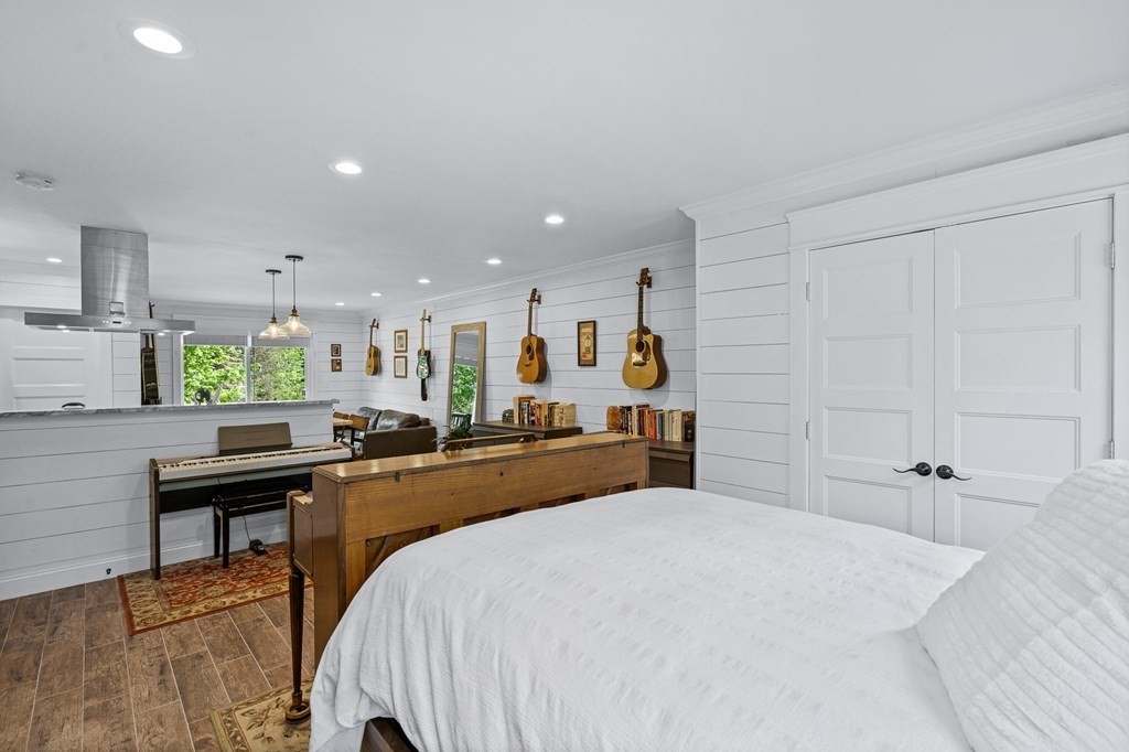 39 Liberty Square Road, Unit D Boxborough, MA 01719 - Photo 16 of 26 a large bedroom with a bed and a table