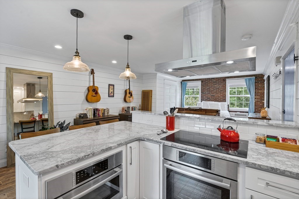 39 Liberty Square Road, Unit D Boxborough, MA 01719 - Photo 4 of 26 a kitchen with a stove and a wooden floor