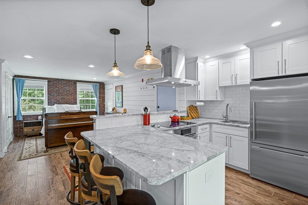 39 Liberty Square Road, Unit D Boxborough, MA 01719 - Photo 5 of 26 a kitchen with stainless steel appliances granite countertop a stove and a refrigerator