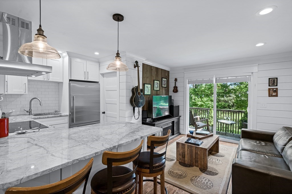 39 Liberty Square Road, Unit D Boxborough, MA 01719 - Photo 6 of 26 a living room with furniture a flat screen tv and a large window