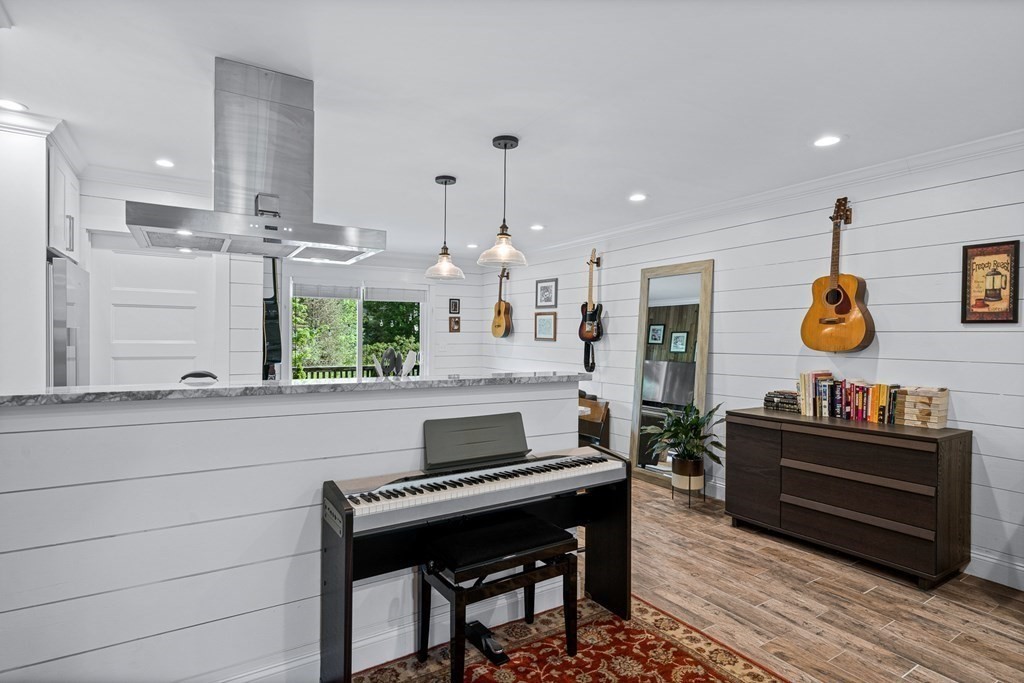 39 Liberty Square Road, Unit D Boxborough, MA 01719 - Photo 7 of 26 a kitchen with a stove and a wooden floor