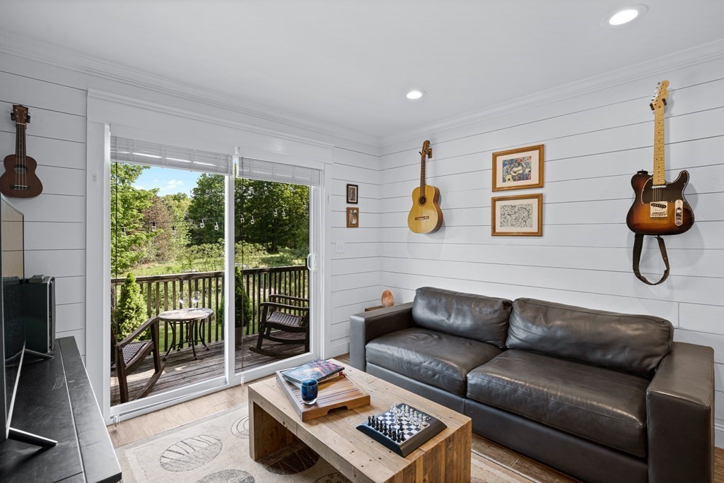 39 Liberty Square Road, Unit D Boxborough, MA 01719 - Photo 10 of 26 a living room with furniture and a floor to ceiling window