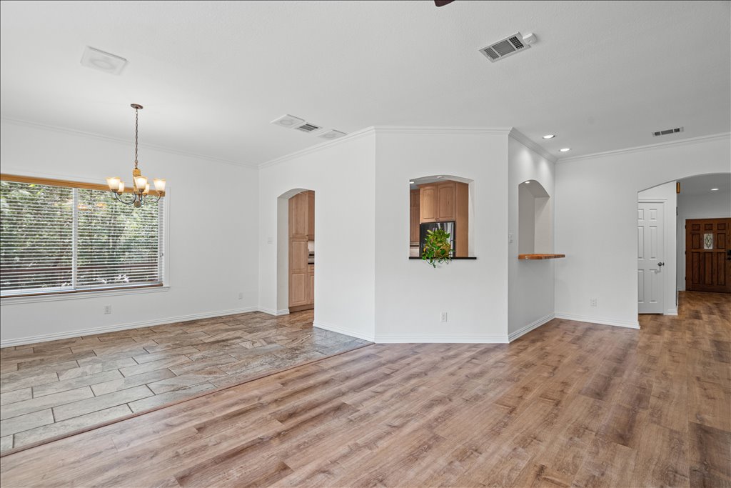 37 Pillow Road Austin, TX 78745 - Photo 5 of 18 Natural light illuminates mixed flooring and elegant archways leading to inviting spaces.