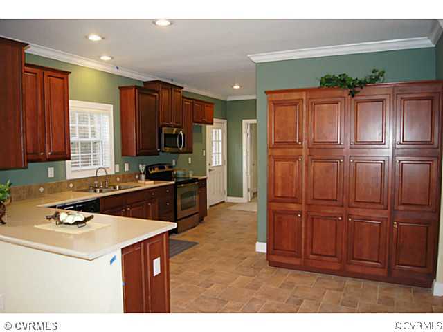 13700 Cedar Creek Road Chesterfield, VA 23838 - Photo 4 of 21 a kitchen with granite countertop wooden cabinets and stainless steel appliances