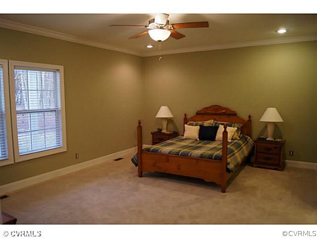 13700 Cedar Creek Road Chesterfield, VA 23838 - Photo 8 of 21 a bedroom with a bed and a chandelier