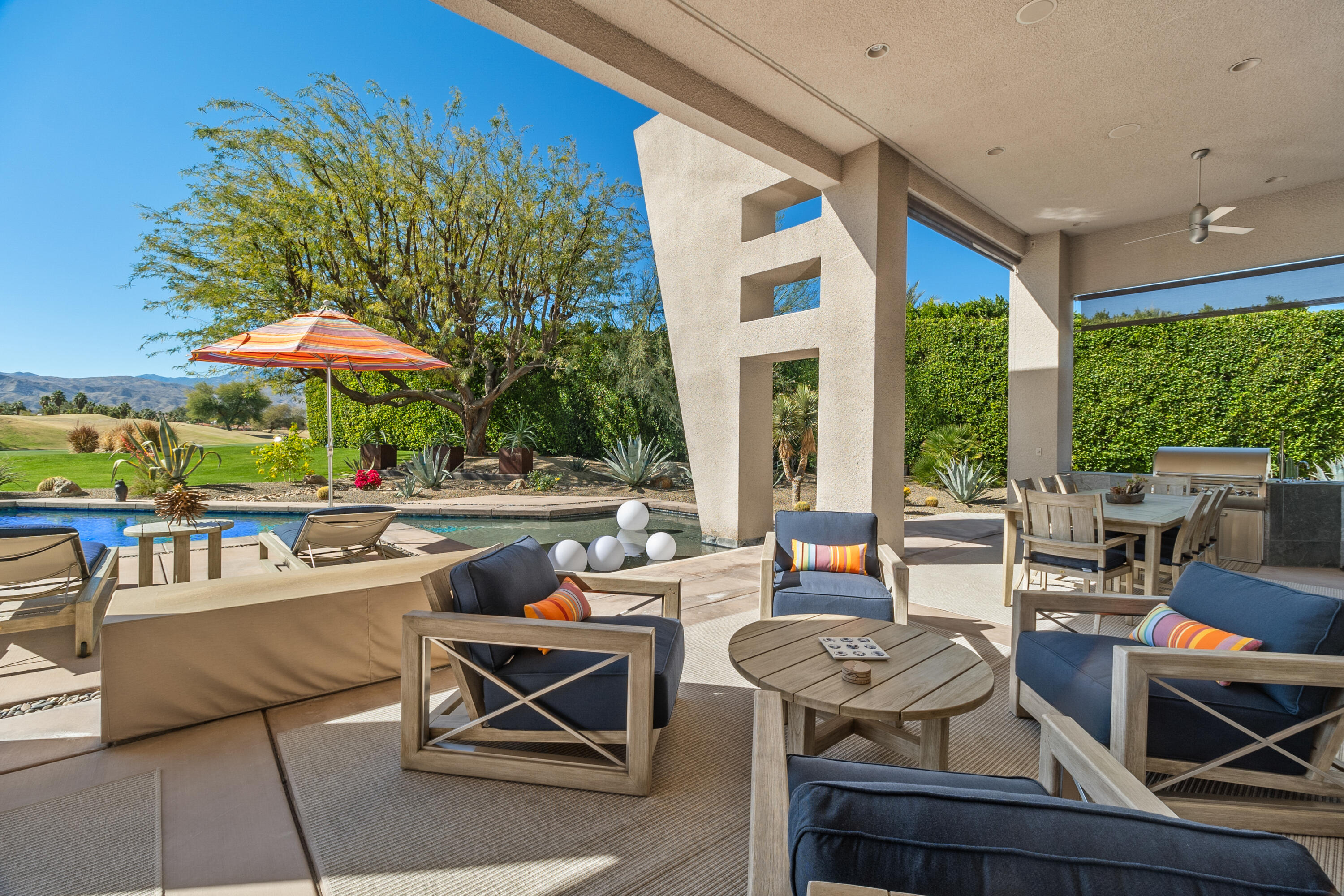 81 Royal St Georges Way Rancho Mirage, CA 92270 - Photo 12 of 59 a living room with patio furniture and a potted plant