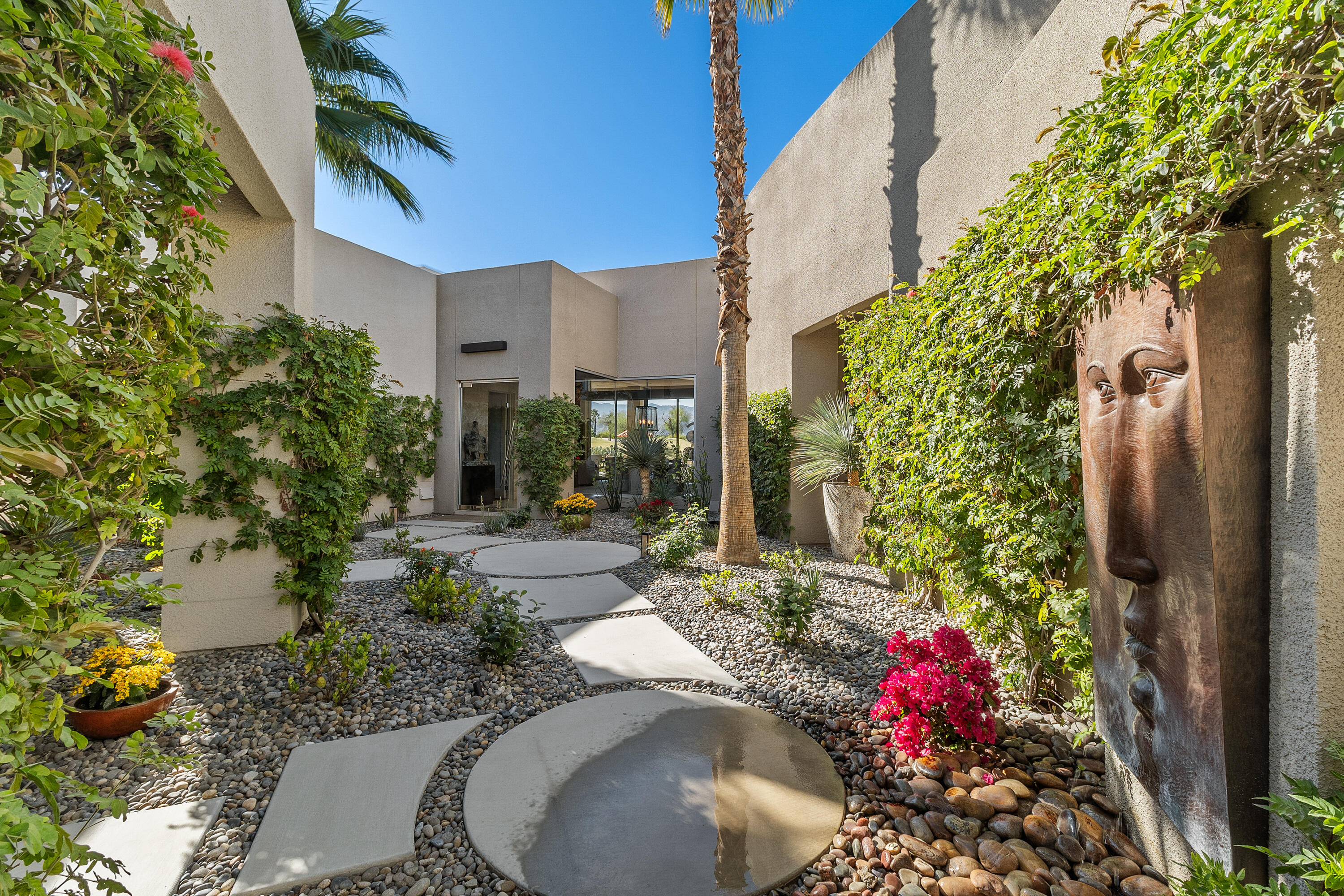 81 Royal St Georges Way Rancho Mirage, CA 92270 - Photo 17 of 59 a view of a patio with plants and chairs potted plants