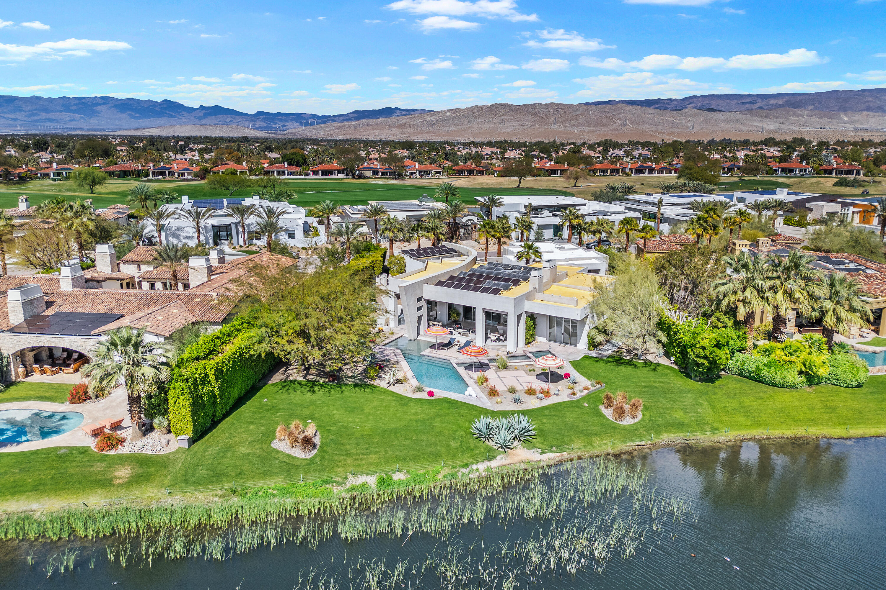 81 Royal St Georges Way Rancho Mirage, CA 92270 - Photo 3 of 59 an aerial view of residential houses with outdoor space and lake view