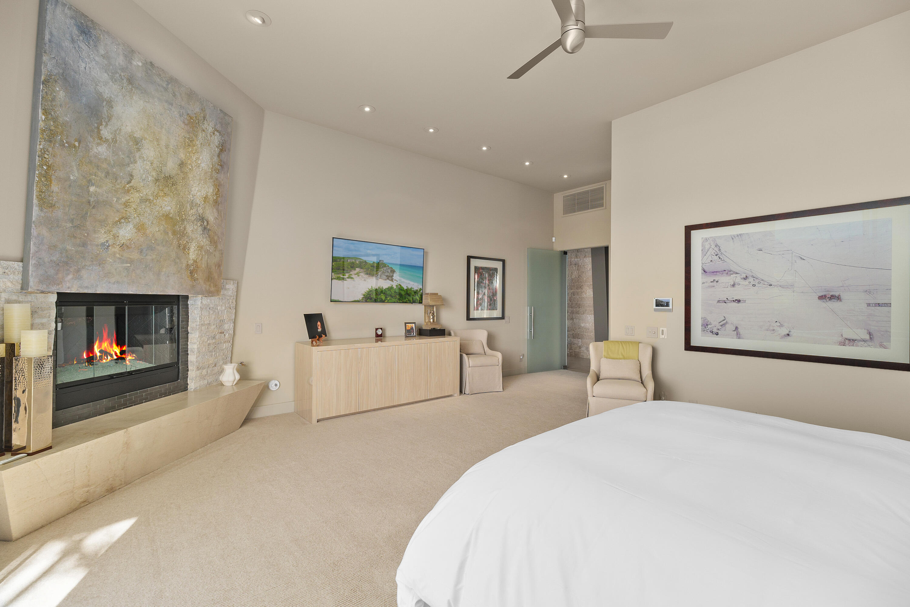 81 Royal St Georges Way Rancho Mirage, CA 92270 - Photo 37 of 59 a spacious bedroom with a bed and a fireplace
