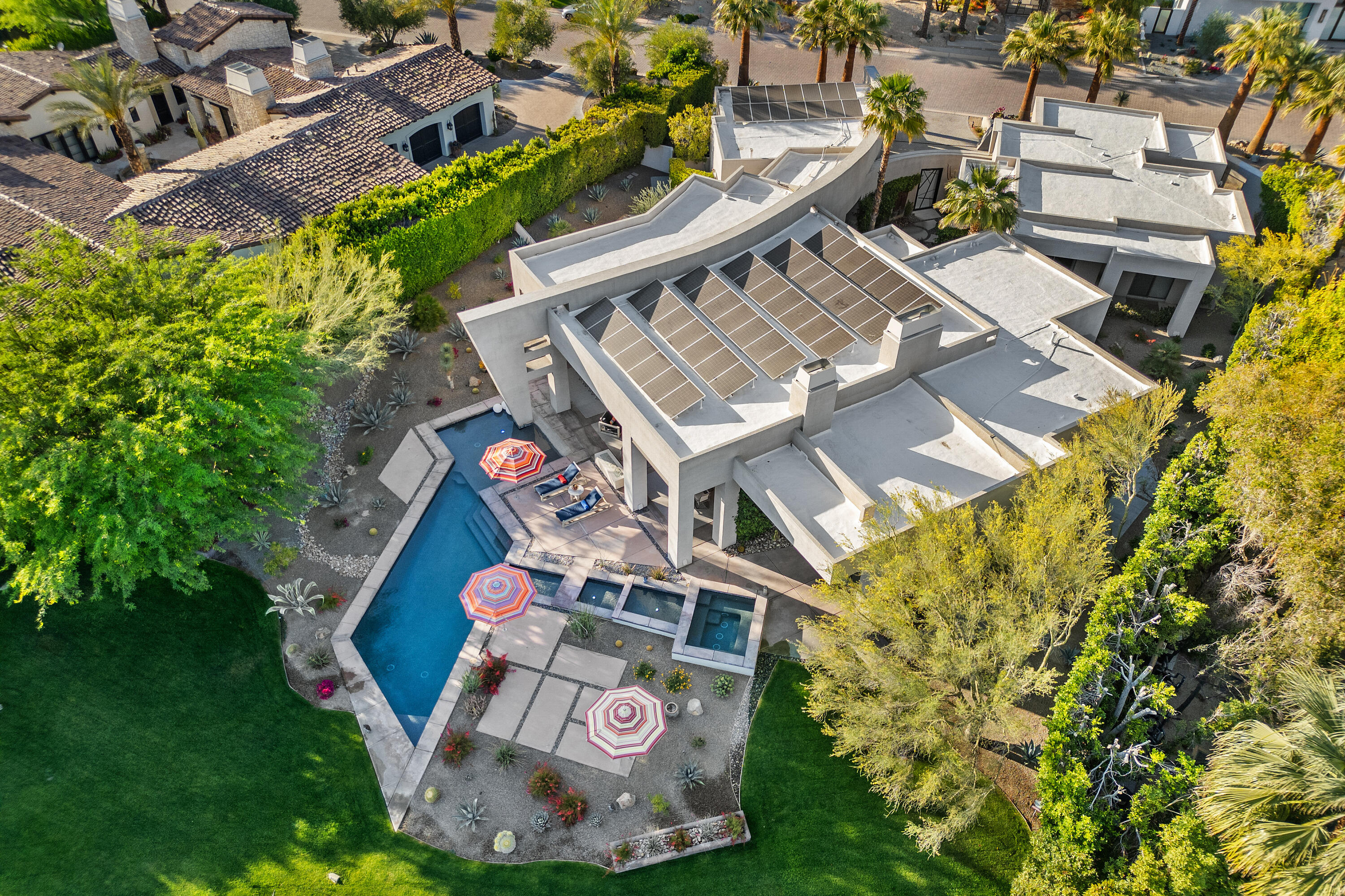 81 Royal St Georges Way Rancho Mirage, CA 92270 - Photo 4 of 59 an aerial view of a house with a garden and trees