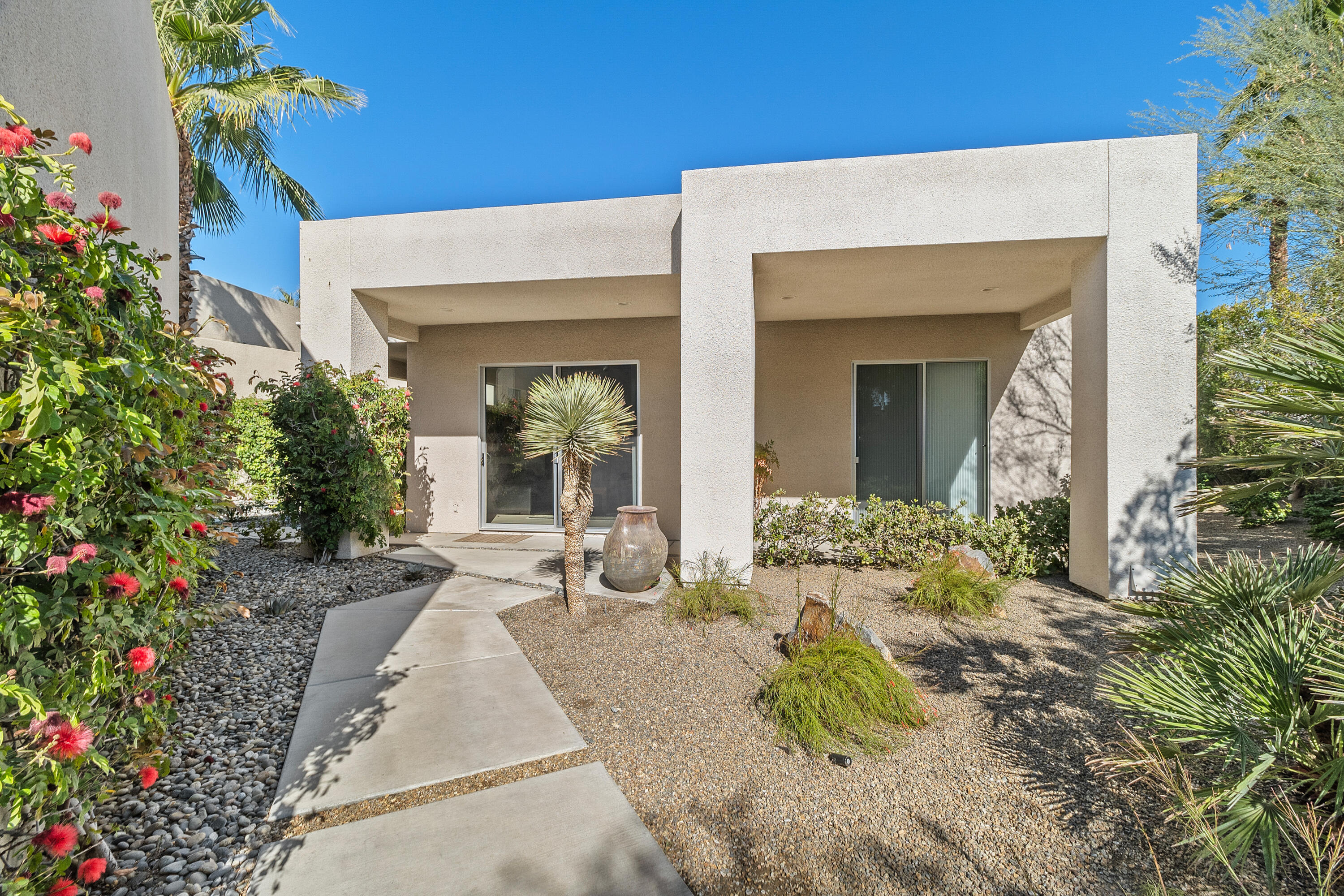 81 Royal St Georges Way Rancho Mirage, CA 92270 - Photo 43 of 59 a view of a house with potted plants