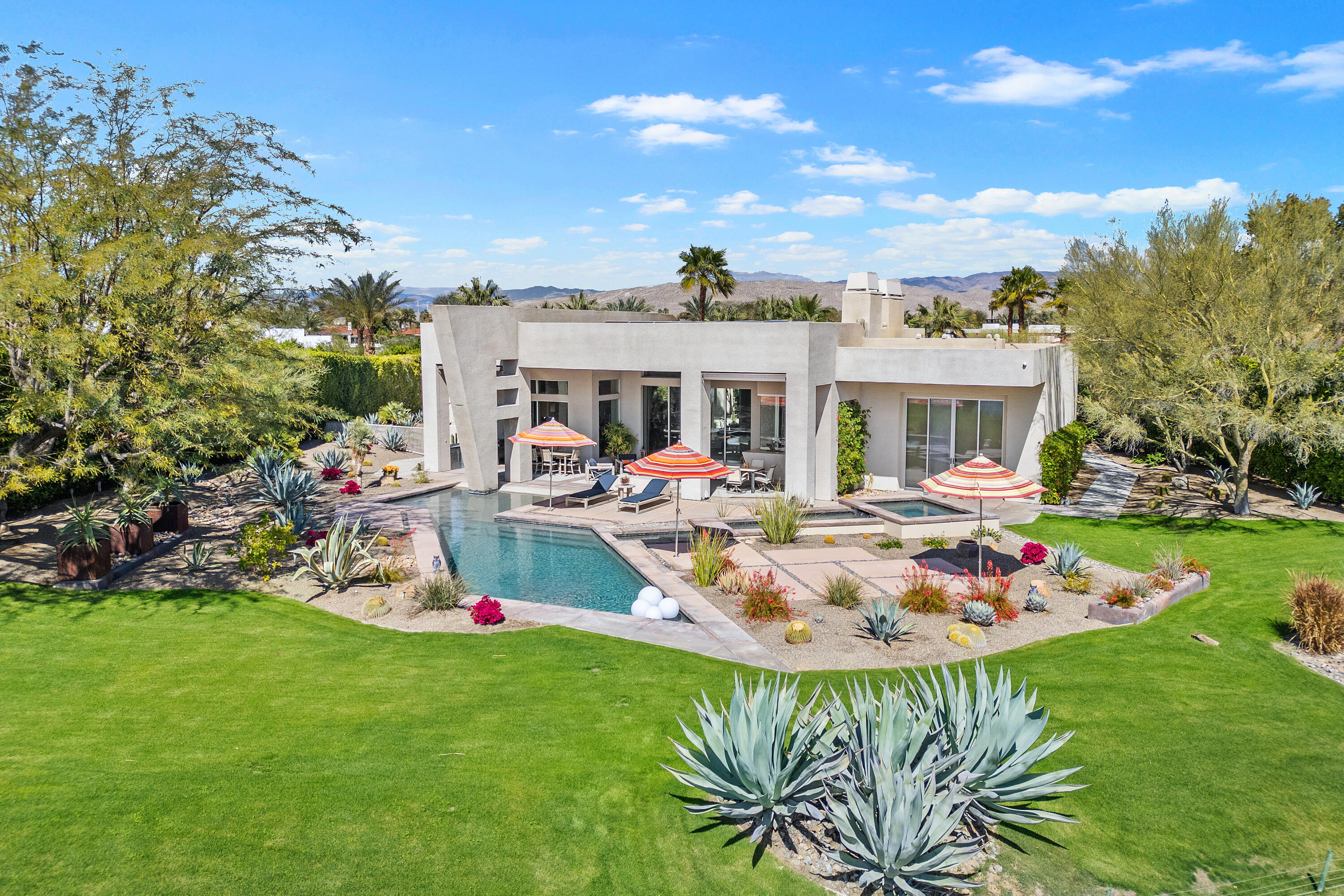 81 Royal St Georges Way Rancho Mirage, CA 92270 - Photo 46 of 59 a view of a house with pool and chairs