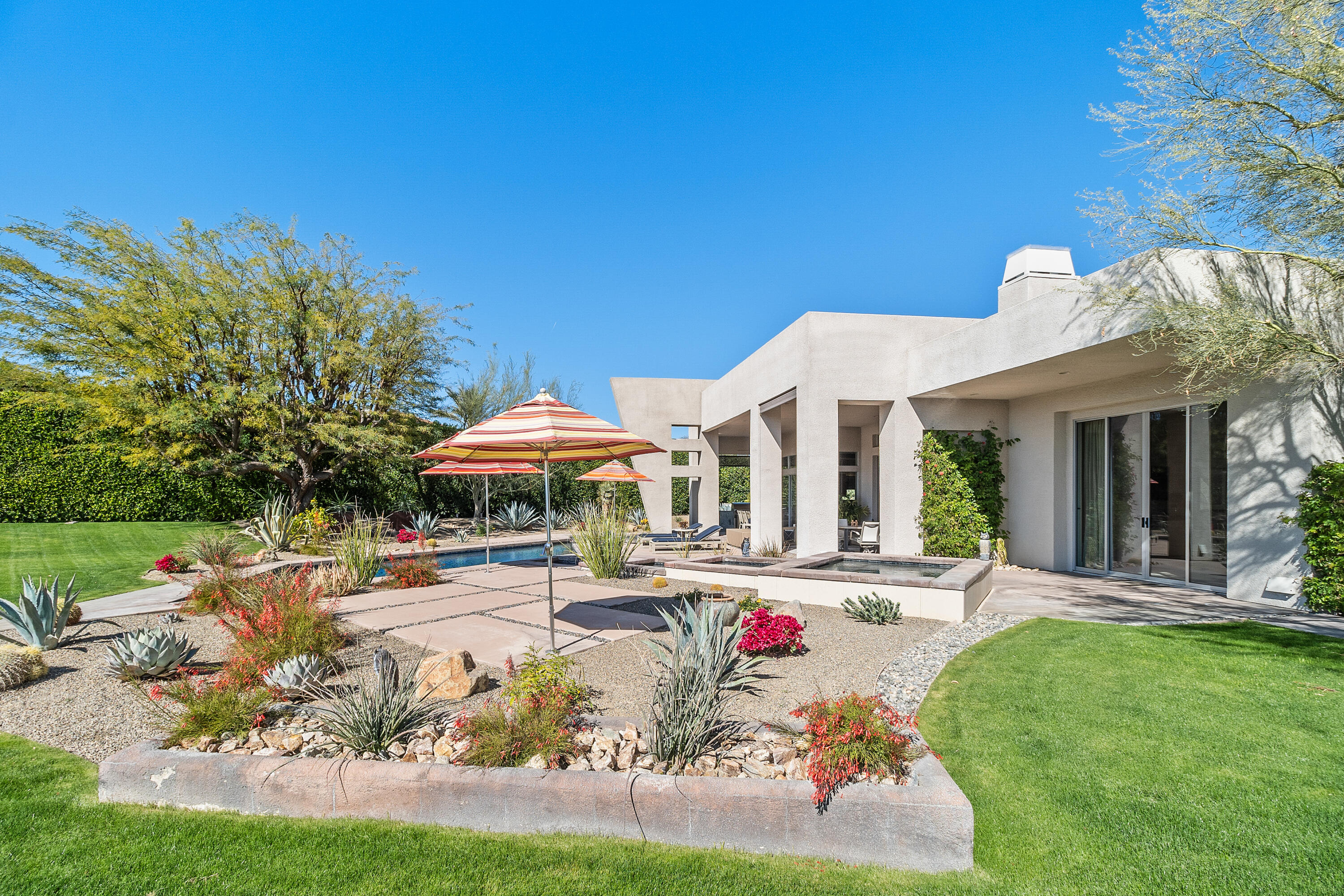 81 Royal St Georges Way Rancho Mirage, CA 92270 - Photo 48 of 59 a front view of a house with garden