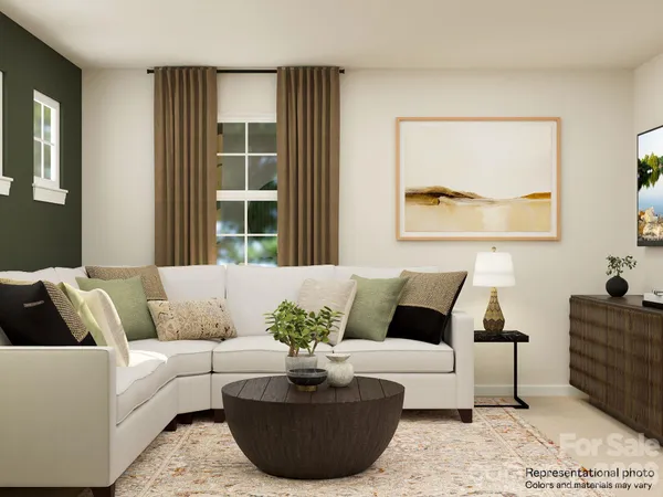 a living room with couches and a potted plant