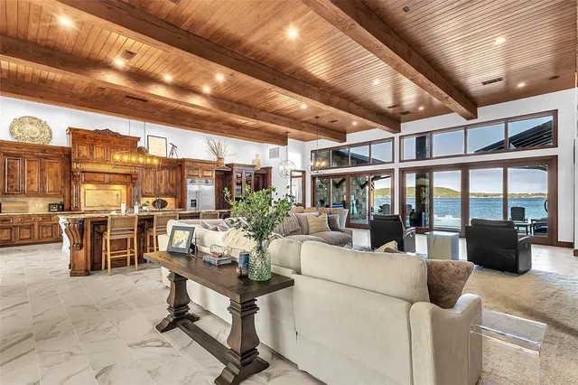 a living room with furniture a fireplace and a ceiling fan